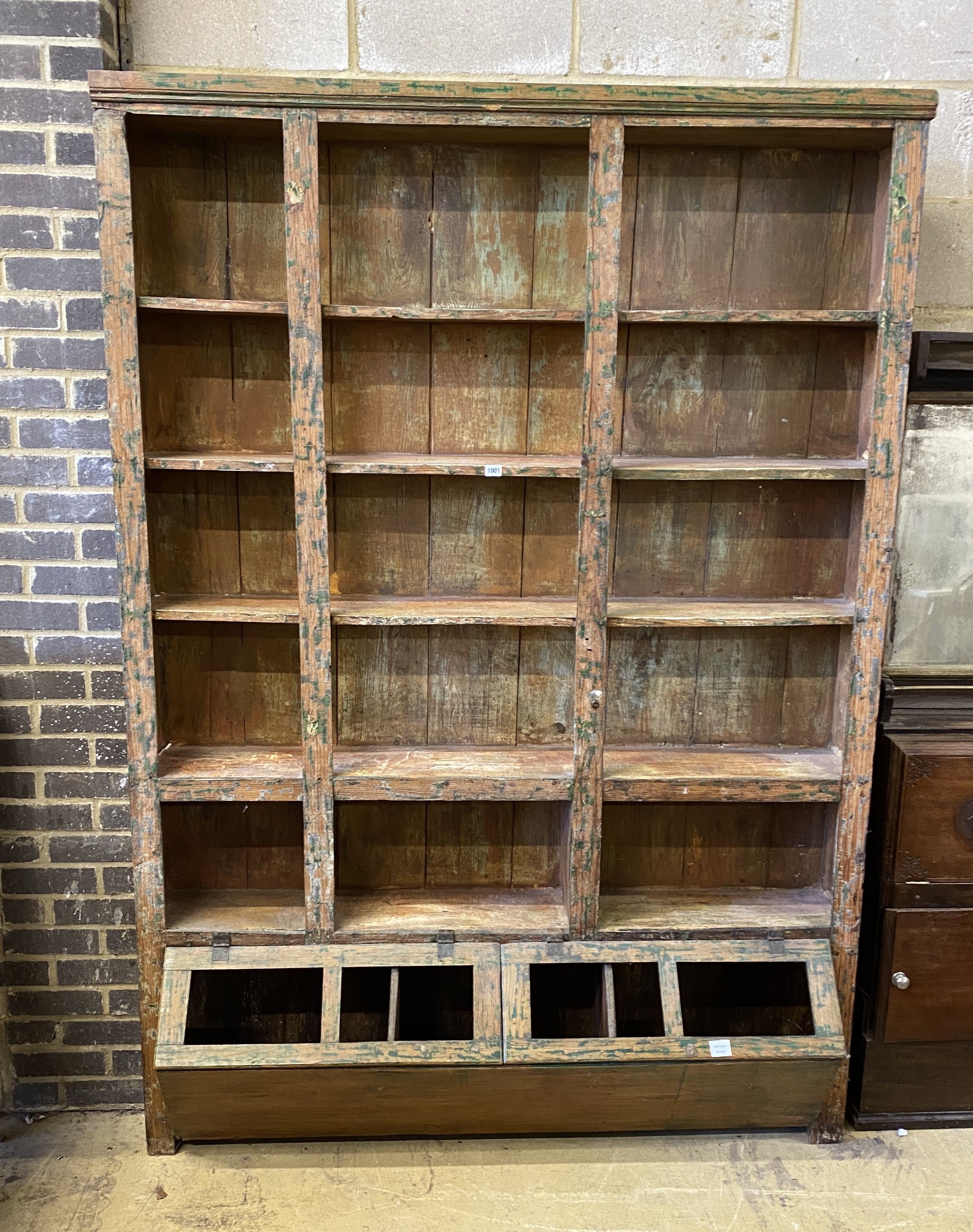 A large 19th century Continental scrubbed pine shop cabinet, width 155cm, depth 38cm, height 219cm